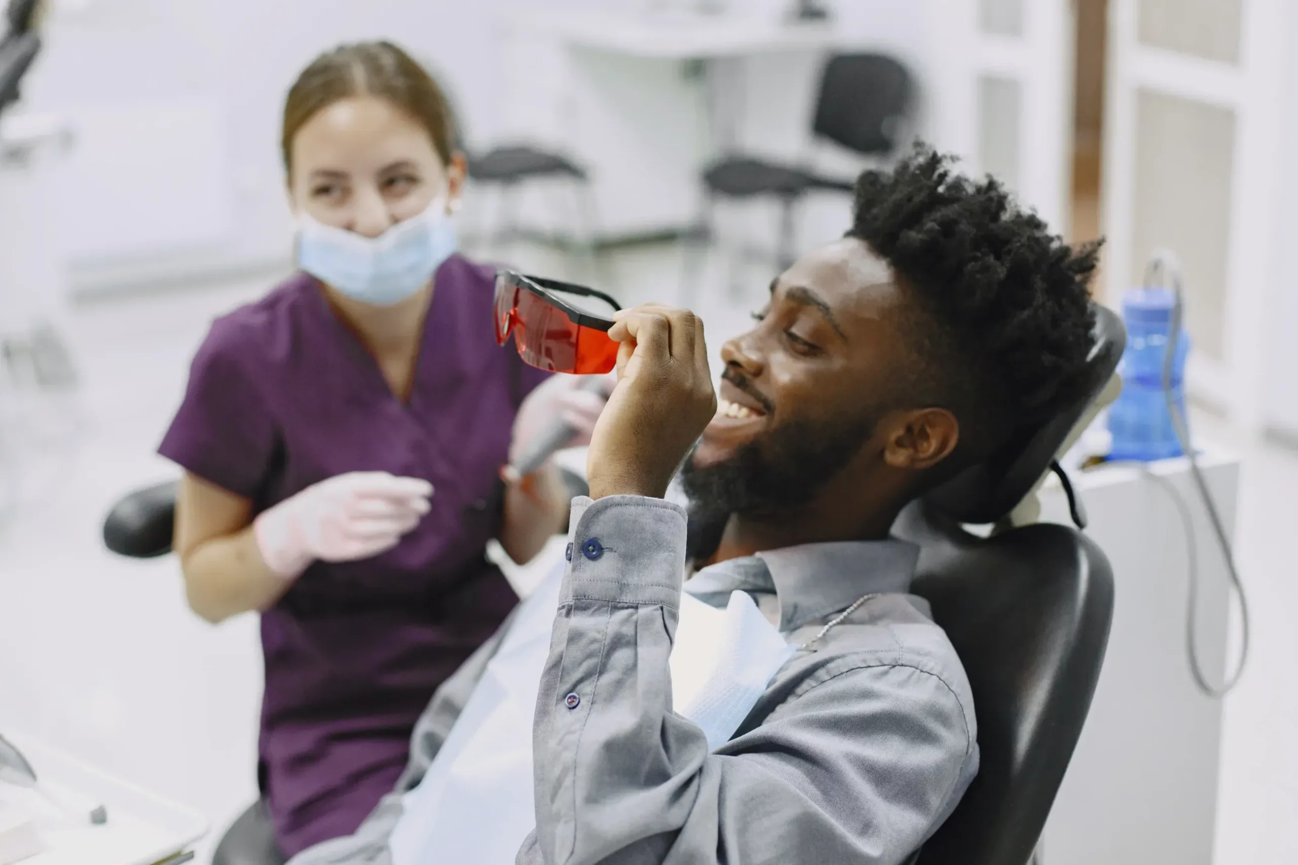 Man putting on dental goggles