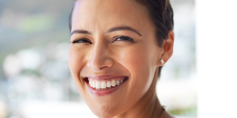 closeup of a woman with a perfect smile, dental implants
